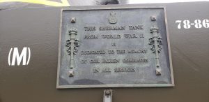 Plaque on Sherman Tank with words: This Sherman Tank from World War II is Dedicated to the Memory of Our Fallen Comrades in all Services